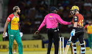 In this handout image provided by CPL T20, Umpire Langton Rusere (C) tries to calm Brendon McCullum (R) of Trinbago Knight Riders and Imran Tahir (L) of Guyana Amazon Warriors during match 30 of the Hero Caribbean Premier League between Guyana Amazon Warriors and Trinbago Knight Riders at Guyana National Stadium on September 9, 2018 in Providence, Guyana. 