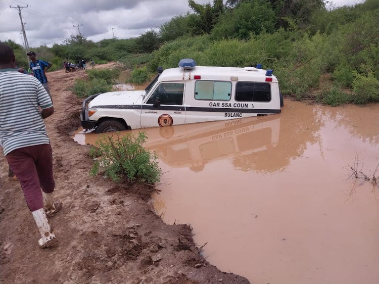 A Garissa county government vehicle submerged in flood waters in Masalani,Ijara sub county on Saturday.