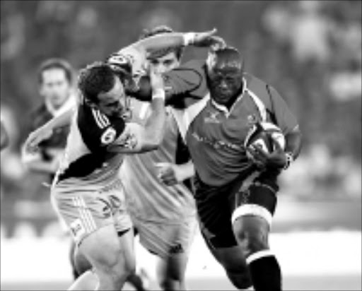 Lawrence Sephaka of the Lions hands off Alby Mathewson of the Hurricanes ©Gavin Barker/Backpagepix