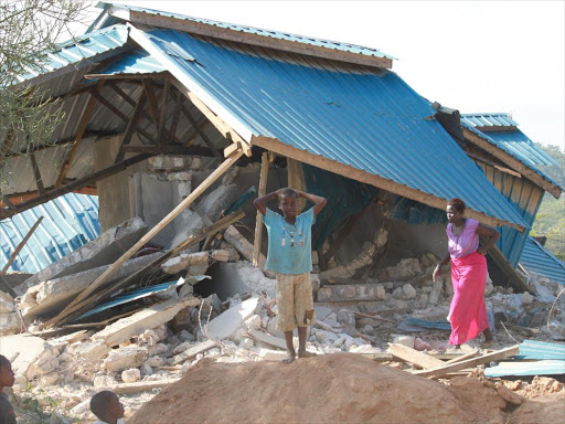A woman ponders next move after her house was demolished by hired youths and bulldozer at Vikwatani area in Kisauni on December 3, 2013./FILE
