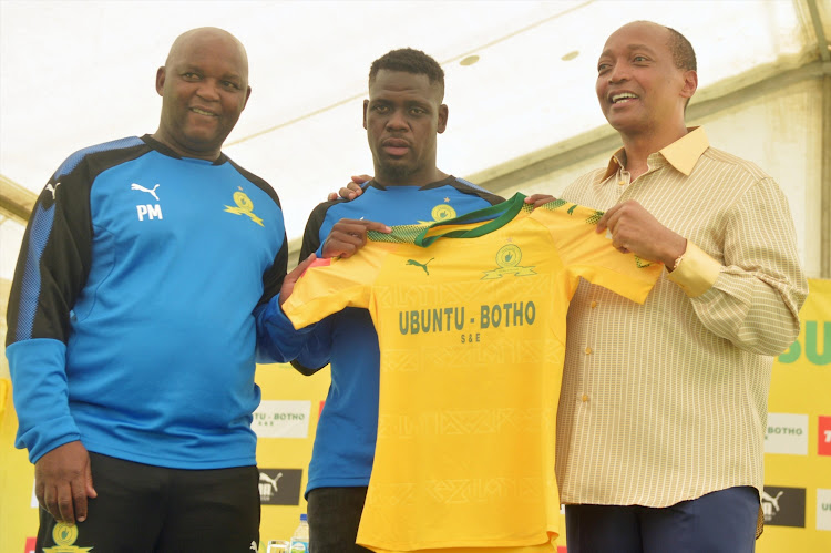 Defender Siyabonga Zulu (C) during his unveiling as a Mamelodi Sundowns new player on January 17 2018 at the club's headquarters in Chloorkop. Flanking him is the club president and billionaire owner Patrice Motsepe (R) and head coach Pitso Mosimane.