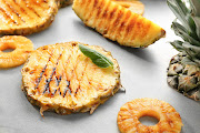 Grilled pineapple pieces. Stock image.