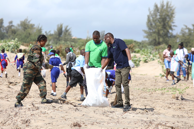 Kenya Wildlife Service officials and other stakeholders take part in the monthly clean-up exercise organised by Progress Welfare Association of Malindi along the Casino beach.