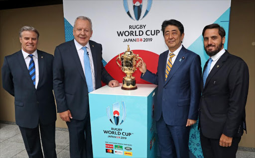 (From L to R) World Rugby CEO Brett Gosper, Chairman of World Rugby Bill Beaumont, Japan's Prime Minister Shinzo Abe and Vice-Chairman of World Rugby Agustin Pichot pose with the William Webb Ellis Cup during the Rugby World Cup 2019 pool draw at the Kyoto State guesthouse in Kyoto on May 10, 2017.