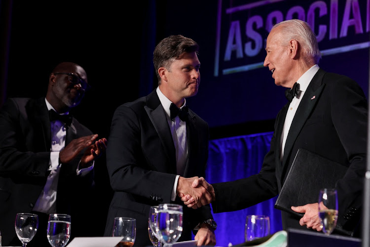 US President Joe Biden shakes hands with host Colin Jost during the White House Correspondents' Association Dinner in Washington on April 27, 2024. Picture: REUTERS/TOM BRENNER