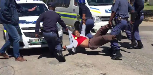 Police drag a student away during protests at Rhodes University on 28 September 2016.