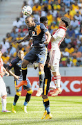 SOME SHUTEYE: Siboniso Gaxa of Kaizer Chiefs leaps to win the ball from Keagan Dolly in yesterday's clash. Chiefs won 1-0