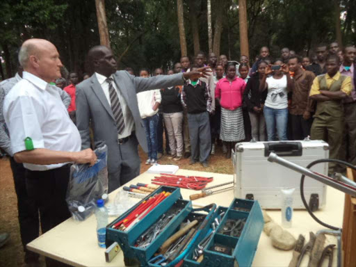 VOCATIONAL TRAINING NEEDED: German Brothers man- ager Klaus Schwenk (L) donates mechanical equipment to Baringo Technical College at Kapsoo on Tuesday.