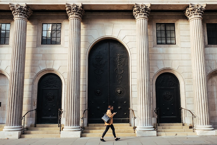 A woman walks passed the Bank of England in London, the UK. Picture: ROBERT BYE/UNSPLASH