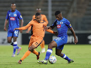 Polokwane City midfielder Oswin Appollis is challenged by Siviwe Magidigidi of SuperSport United during their DStv Premiership match at Lucas Moripe Stadium.
