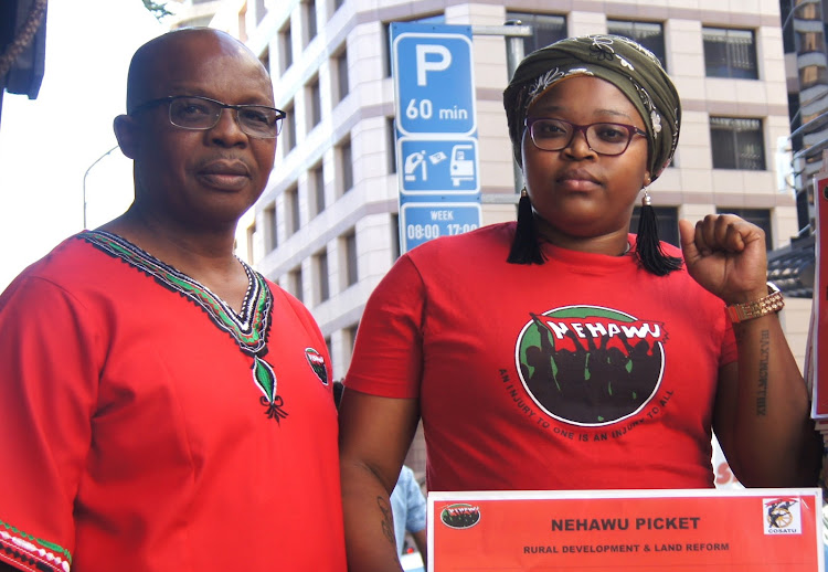 Caption: Nehawu members Siyanda Ngudle and Lungiswa Nante picket in Cape Town on Wednesday.