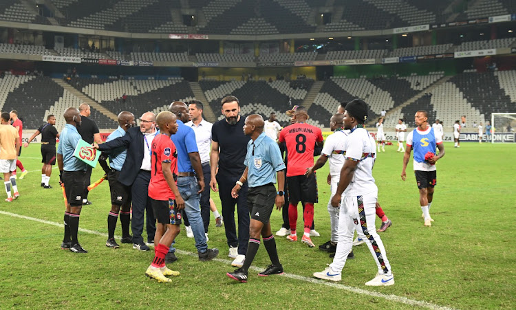 TS Galaxy team members confront match officials during the DStv Premiership match against Stellenbosch at Mbombela Stadium at the weekend.