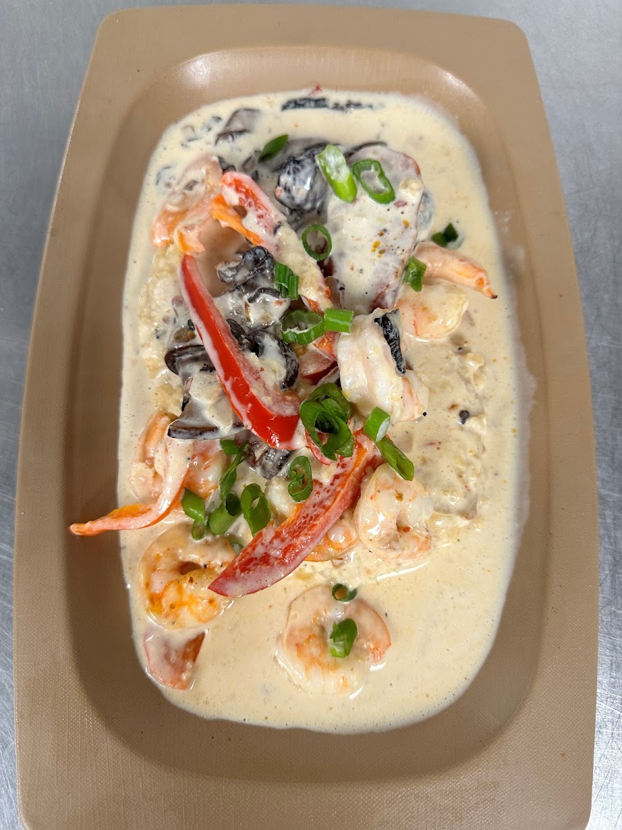 Shrimp + Grits - White shrimp, sherry cream, andouille sausage, red bell peppers, portabella mushroom, and green onions over creamy  grits