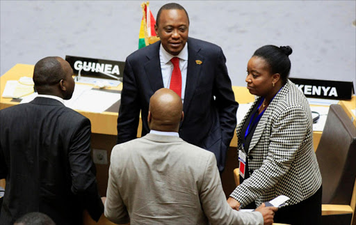 Kenya's President Uhuru Kenyatta (C) talks to Kenyan delegates during the Extraordinary Session of the Assembly of Heads of State and Government of the African Union on the case of African Relationship with International Criminal Court (ICC), in Ethiopia's capital Addis Ababa. Reuters