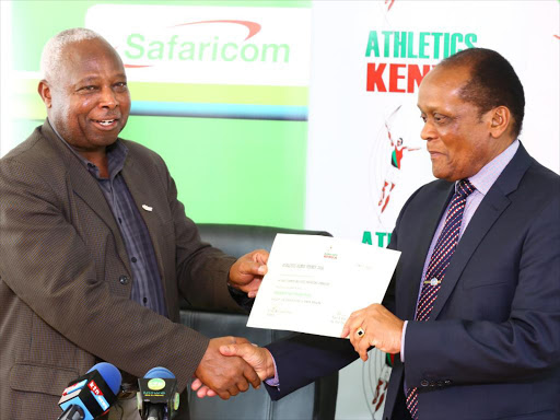 Athletic Kenya president Jackson Tuwei, present a permit certificate to Marsden Madoka for the Madoka half Marathon. Safaricom will sponsor the race. /COURTESY