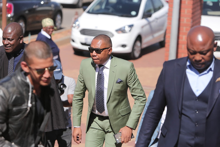 Former Higher Education Deputy Minister Mduduzi Manana (in green) enters the Randburg Magistrates Court in Johannesburg for sentencing. Manana was convicted of three charges of assault with intent to do grievous bodily harm. Image: ALAISTER RUSSELL