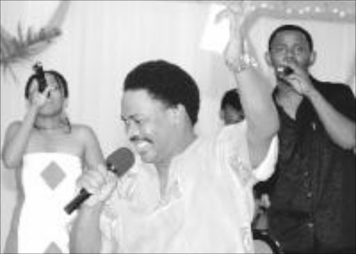 A MESSAGE IN SONG ... Singer Stompie Mavi singing at the Coega World Aids Day function yesterday. Pic: IVOR MARKMAN. 02/12/03. © The Herald.