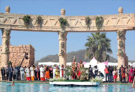 This file photo courtesy of the Gupta family released on May 3, 2013 shows Vela Gupta and her husband Indian-born Aaskash Jahajgarhia posing with relatives and guests during ceremonies for their wedding in Sun City, South Africa, on May 1, 2013. Image: AFP / COURTESY OF THE GUPTA FAMILY / Handout