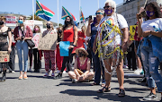 Venetia Orgill, an ambassador for SA women Fight Back, attended the protest wrapped in chains and police tape. 