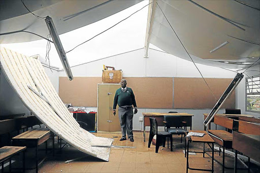 SHATTERED: Principal of Nobhotwe Primary school Mkhululi Mngxekeza stands in the remains of a temporary classroomPicture: SIBONGILE NGALWA