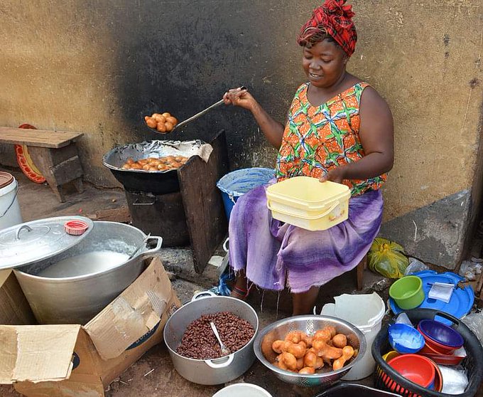 A Cameroonian street vendor making puff-puffs.