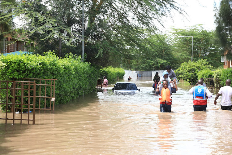 An official from the emergency response unit carries a man out of the marooned residential estate in Athi River, Machakos on April 24, 2024.