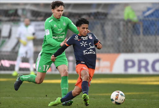 Saint-Etienne's Norwegian midfielder Ole Kristian Selnaes (L) fights for the ball with Montpellier's South African midfielder Keagan Dolly (R) during the French L1 football match between MHSC Montpellier and AS Saint Etienne, on February 19, 2017 at the La Mosson Stadium in Montpellier, southern France.