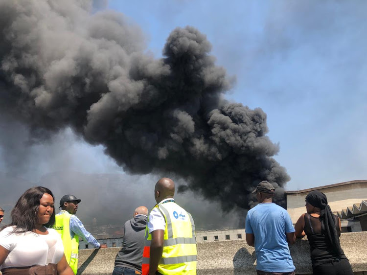 Thick smoke billows from the Cape Town train station where two trains were set alight on October 9 2018.
