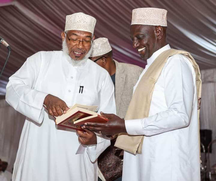 President William Ruto and Jamia Mosque Committee Vice Chair Prof. Abdulatif Essajee holding a Quran on April 17, 2023