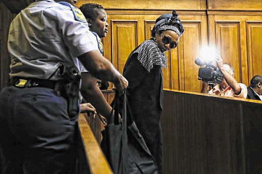 BACK IN BLACK: Thandi Maqubela, who killed her judge husband in 2009, appears in the Cape Town High Court yesterday for her lawyers to present arguments in mitigation of sentence