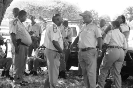 GUNS DOWN: A group of traffic officers in the Polokwane municipality in Limpopo picketed at the local traffic station in protest against 'harassment' by their superiors. Pic. Elijar Mushiana. 18/03/2010. © Sowetan.