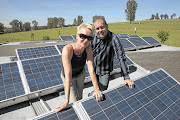 Dorris and James Forbes on the roof of their R29-million home, which is powered by solar panels Picture: RAYMOND PRESTON