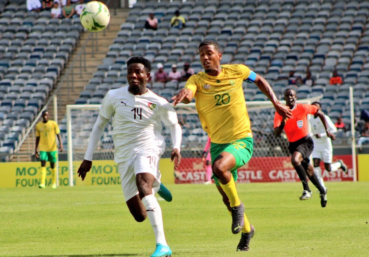 Togo Under-23's Kokou Avotor attempts to sprint clear of South Under-23 captain Rushwin Dortley in the U-23 Africa Cup of Nations second round, second leg qualifier at Orlando Stadium on October 30 2022.