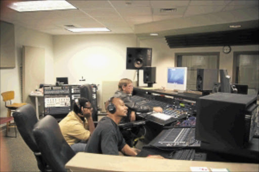 MONITORING NOISE: Sound engineers at work in a recording studio.