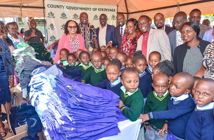 Kirinyaga governor Anne Waiguru, county staff, teachers and ECDE learners during the distribution of a complete set of uniform to each learner in the county in Kutus Thursday
