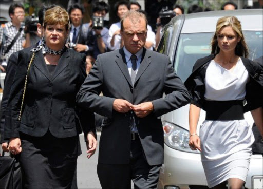 The family of slain 22-year-old British teacher Lindsay Ann Hawker, father Bill Hawker (C), mother Julia (L) and sister Lisa (R) arrive at Chiba District Court in Chiba, suburban Tokyo, on July 4, 2011. File photo.
