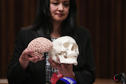 Forensic Pathologist Dr Shakeera Holland shows off a skull during the inquest into the death of Ahmed Timol at the North Gauteng High court in Pretoria. Holland's findings suggest that Timol had suffered serious injuries prior to the fall from the 10th floor of John Foster Square in Johannesburg on 1971.Picture:Alaister Russell/ The times