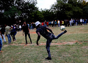 Voters play soccer as after ballot paper shortages at the Pretoria West High School resulted in long queues and long waits on Wednesday May 8 2019.