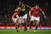 Wales scrum half Aled Davies (l) and Rob Evans chase Springboks player Siya Kolisi during the International between Wales and South Africa at at Principality Stadium on December 2, 2017 in Cardiff, Wales.