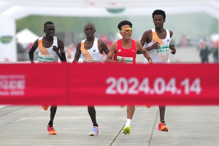 Chinese runner He Jie, Ethiopian Dejene Hailu Bikila and Kenyans Robert Keter and Willy Mnangat take part in a half-marathon in Beijing, China April 14, 2024. Picture: REUTERS