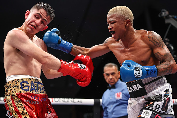 Sivenathi Nontshinga catches Adian Curiel on the cheek with a powerful punch during their IBF World Light Flyweight Title fight at the Guelaguetza Auditorium in Oaxaca, Mexico.