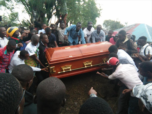 Rongo University students lower Sharon’s coffin into her grave in Homa Bay on Friday. Below: Sharon’s mother Melida Auma at the burial /ROBERT OMOLLO