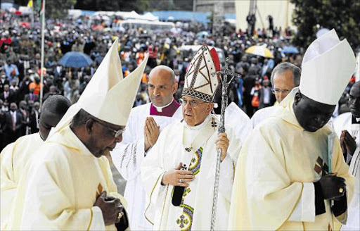 VOICE OF PEACE: Pope Francis, centre, arrives in procession to celebrate Mass on the campus of the University of Nairobi, Kenya, yesterday. The pope is also visiting Uganda and the Central African Republic during his six-day African tour