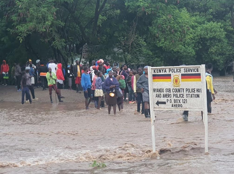 Locals next to Ahero police station on Sunday, May 5, 2024 after River Nyando broke its banks.