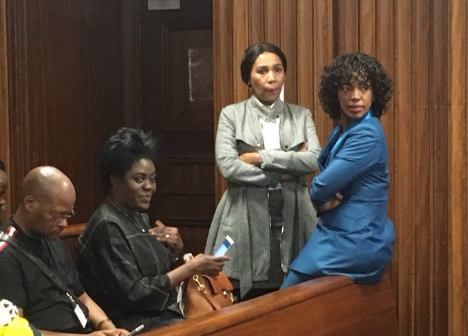 Timothy Omotoso’s wife Taiwo (seated) talks to the co-accused Lusanda Sulani and Zukiswa Sitho in the Port Elizabeth high court on July 30 2019.