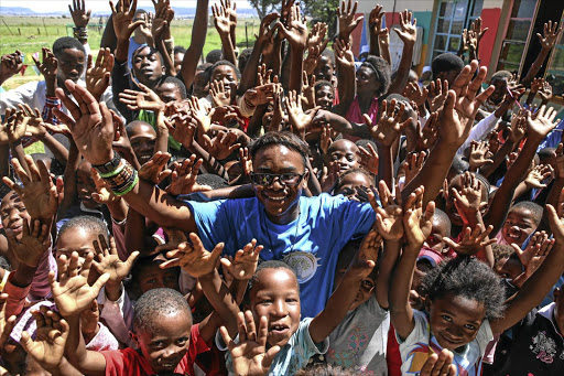 MAKING WAVES: Deputy principal and teacher Tshepo Mabaso with some of the pupils of Lethotheng Learning Centre, near Clocolan , in the Free State. Lethotheng gives undocumented children an education Picture: