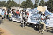 TOYI-TOYING: Members of the Wildebeesfontein Community Organisation protest against 'illegal' evictions outside the Sebokeng magistrate's court yesterday. Pic: LEN KUMALO. 11/08/2009. © Sowetan.