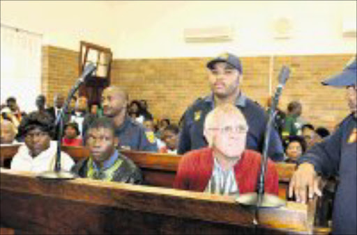 FREE AGAIN: Maria Mnisi, Phineas Johnson and Fanie Hyman, who ordered the couple to exhume their child on his farm, together in the dock before charges against the couple were dropped in the Koppies magistrate's court. Pic. Peter Mogaki. 22/04/08. © Sowetan.