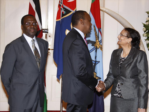 President Uhuru Kenyatta congratulates Deputy Chief Justice Kalpana Rawal after she was sworn in at State House on June 3, 2013. Looking on is Chief Justice Willy Mutunga /PSCU