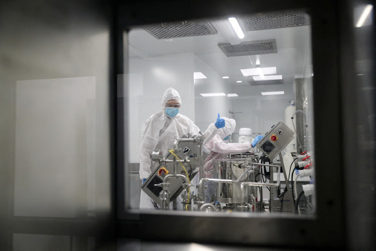 Production scientists work in a laboratory at biotech start-up Afrigen Biologics in Cape Town.